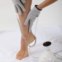 Bioenergetic Meridian Massager in use, with gloves applying treatment on leg, showcasing multifunctional therapy features.